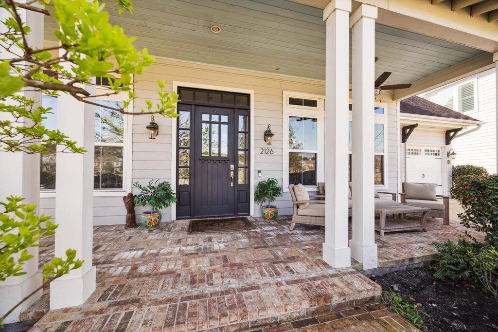Oversized front porch allows for multiple furniture configurations.