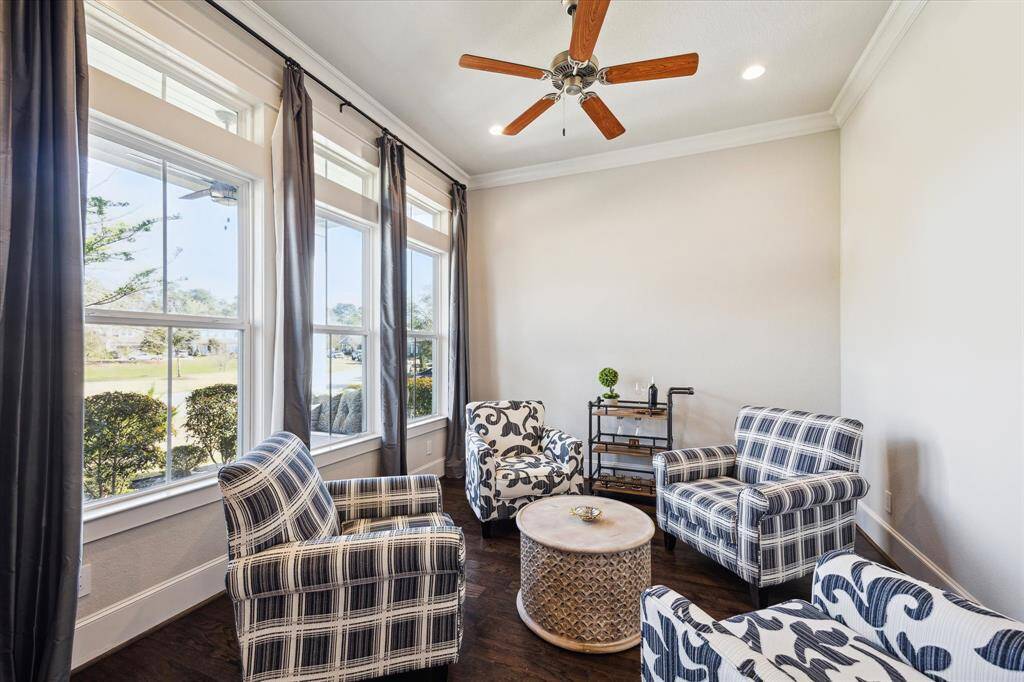 Front sitting room can be used as an office or a space for lounging. Photo has been virtually enhanced.