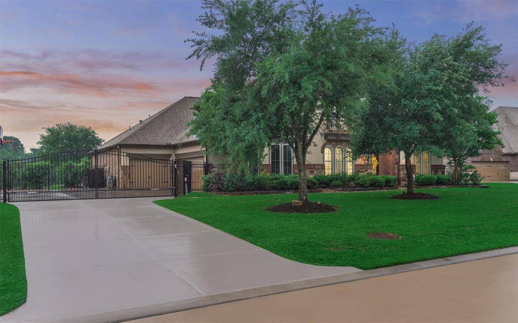 Double wide driveway with iron automatic gate