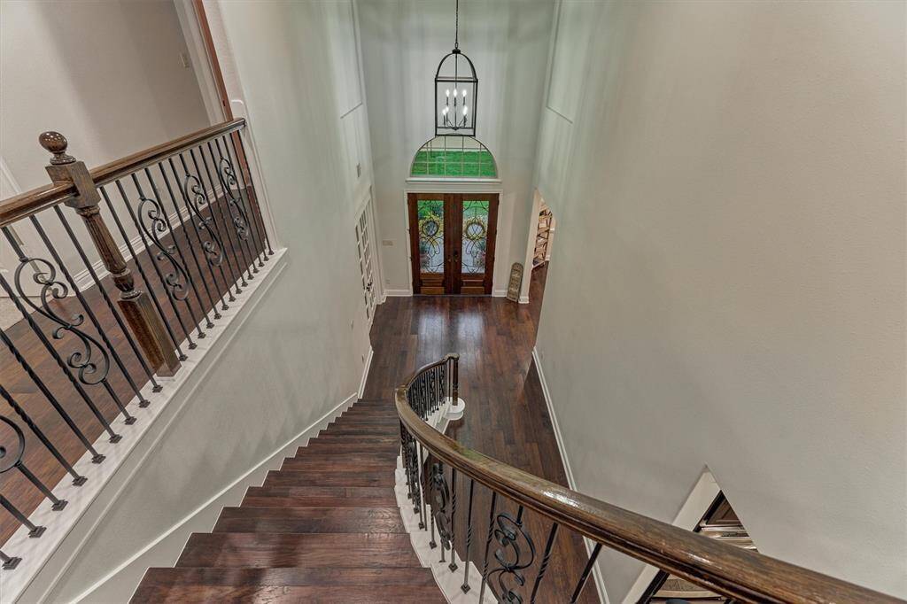 This home features two staircases, this is the staircase at the front of the house.  Upstairs you’ll find three additional bedrooms and three additional full bathrooms as well as a game room