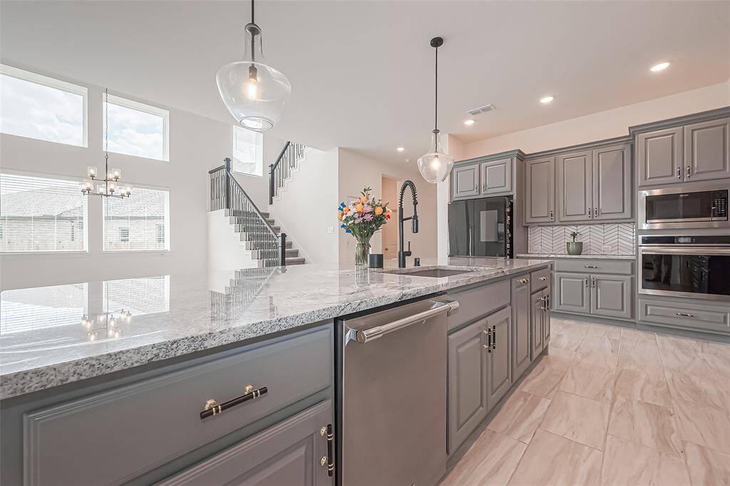 Your island features comfortable seating, dishwasher, smart storage solutions, including a trash drawer, sleek sink for food prep and entertaining.
