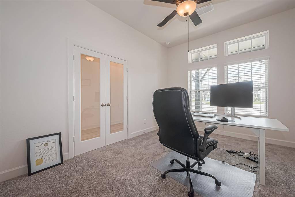 The home office offers glass double doors, floor outlets, natural light and ceiling fan.