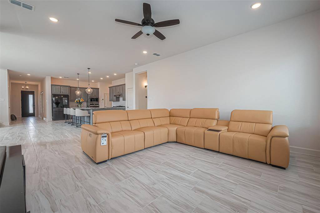 Unwind in style in this living room with expansive windows, ceiling fan and recessed lights.