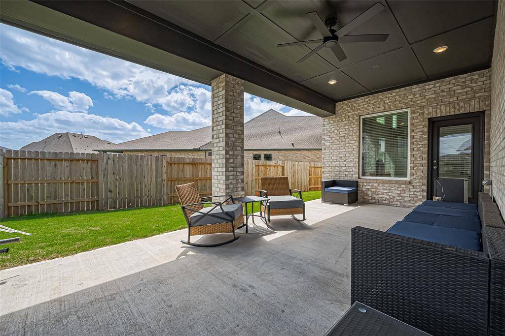 Extend your living space outdoors and enjoy the finest in alfresco entertainment on this gorgeous covered patio featuring black-paneled ceilings, recessed lights, two ceiling fans, and pre-plumbed for gas and water.