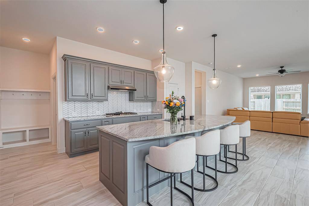 This stunning open-concept kitchen with upgraded Kent Moore cabinets, sleek countertops, and modern finishes is perfectly designed for entertainment.