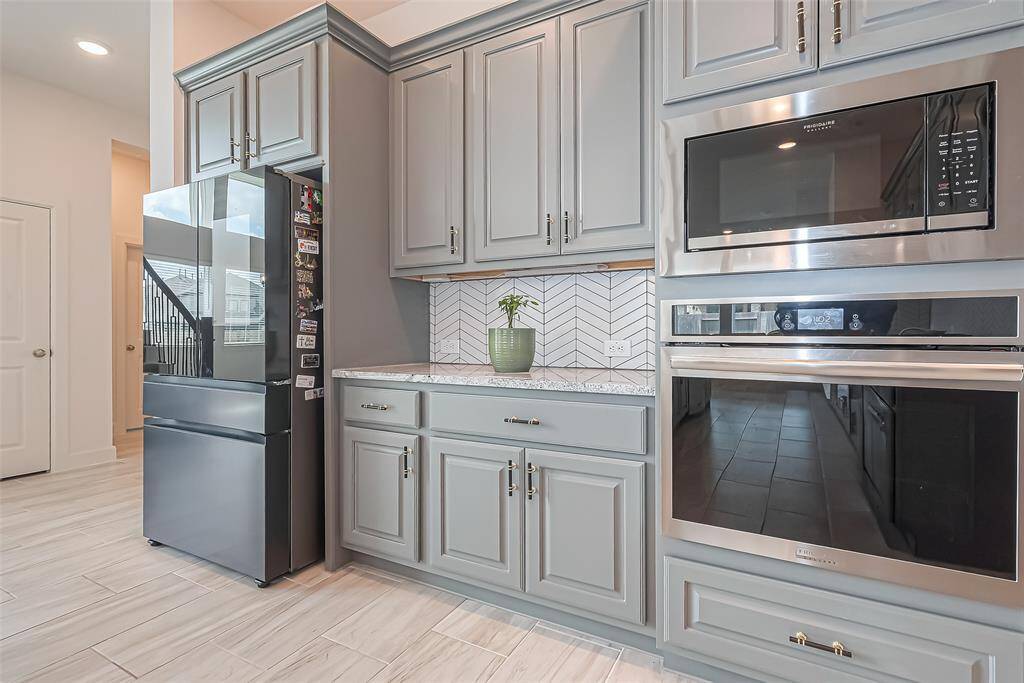 Beautiful appliances, chevron pattern backsplash, and gorgeous cabinets add function and charm to this home.