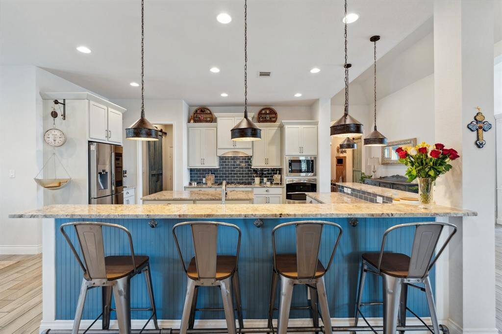 The kitchen brings everyone together, with effortless flow into the breakfast nook, dining room, and cozy living area