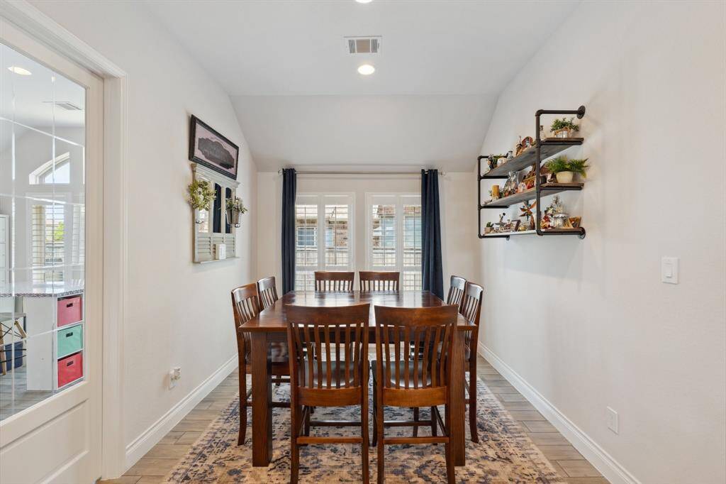 Located just off the garage, the mudroom has been thoughtfully transformed into a stylish beverage center—complete with a wine rack, wine fridge, and ice maker