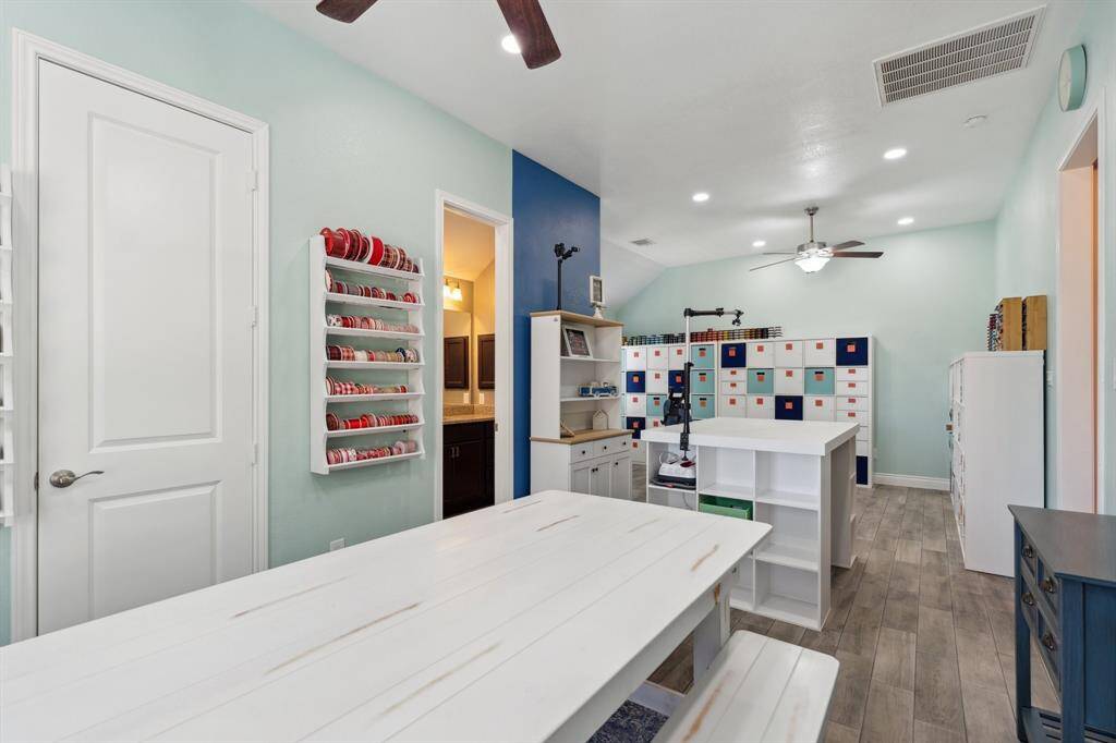 Bright and welcoming, the breakfast nook is adjacent to the flex/game room and framed by a wall of sun-filled windows.