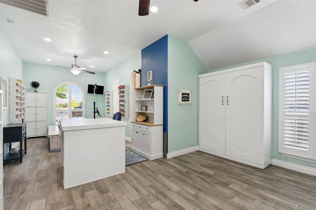 This well-appointed bathroom is shared by the converted, 2 bedroom flex space and features a modern vanity, framed mirror, and a full tub with shower.