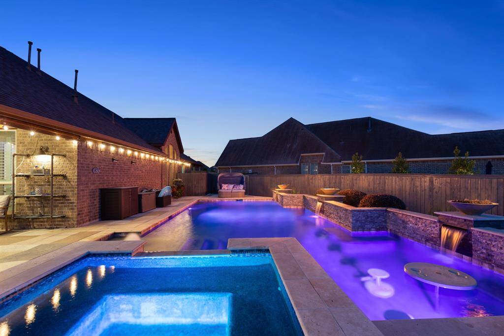 Ultimate Outdoor Entertaining SpaceThis expansive covered patio includes a 2 built-in grills, ceiling fans, custom built pergola, and multiple lounging and dining areas—perfect for gatherings, game nights, or relaxing in style.