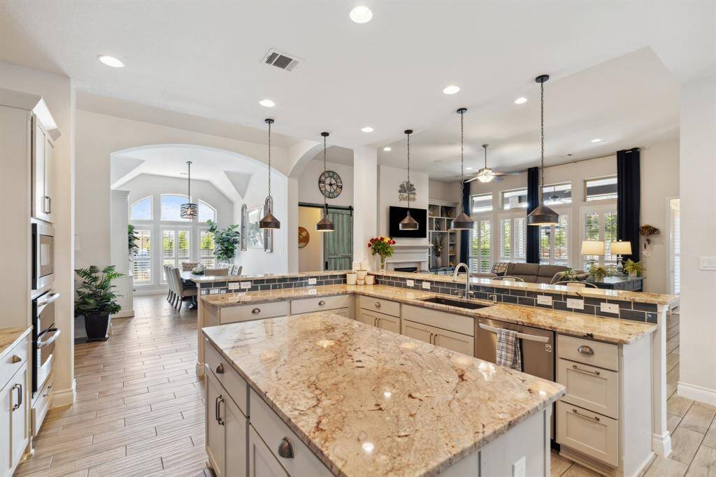 This gorgeous kitchen invites you to cook, connect, and enjoy—with open views to the living spaces and the covered patio