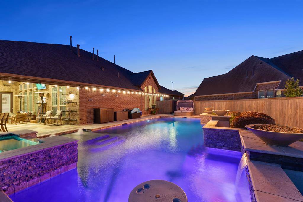 Private backyard oasis with pool, spa, pergola, and plenty of grass for pets and play.