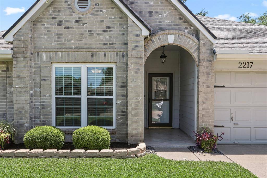 Charming, covered entrance with updated tile flooring.