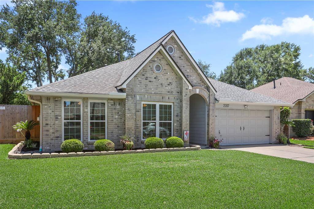 Another view of the meticulously maintained lawn, updated windows and roof.