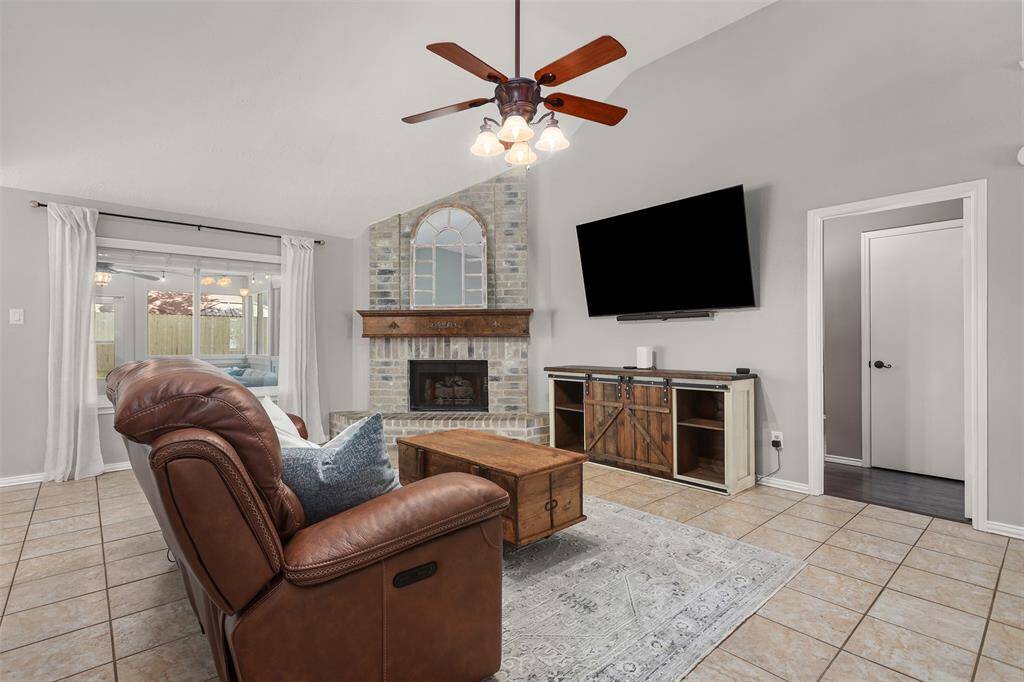 Another view of the living space. Primary bedroom is through the opening to the right of the television.