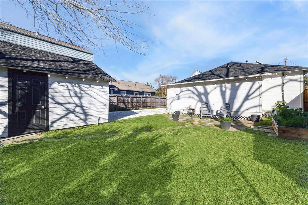 Backyard with door leading to garage