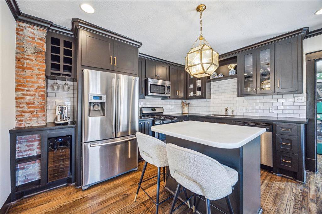 Original brick detail adds charm to this beverage corner complete with small fridge