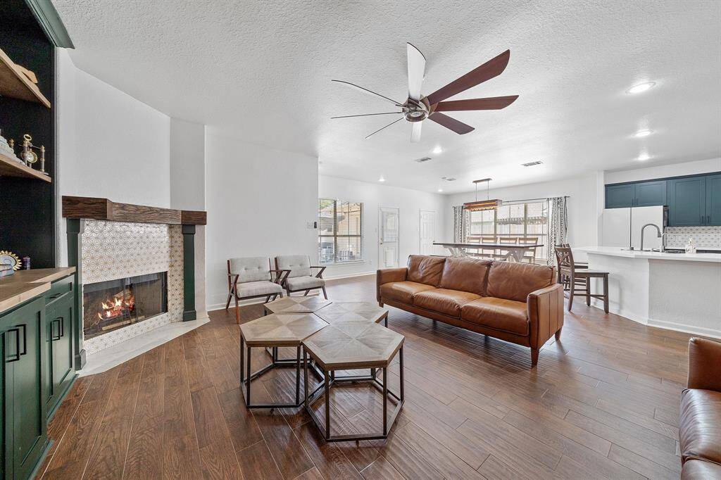 WOW! This living room is the perfect place to entertain family and friends as it offers a seamless, open floor plan. Easy access to your amazing kitchen and dining space!