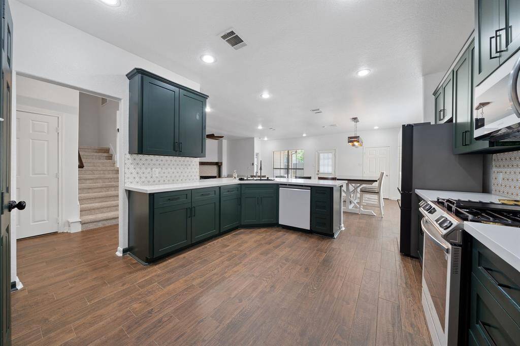 This kitchen is conveniently located providing easy access to the stairs, living and dining spaces.