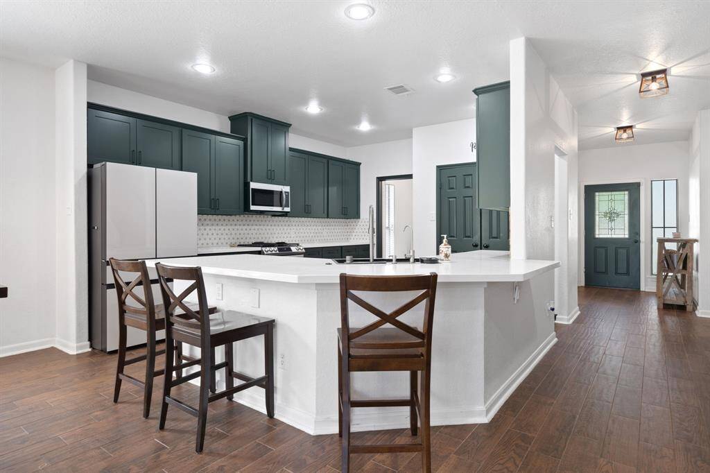 This beautiful kitchen is complete with a breakfast bar!