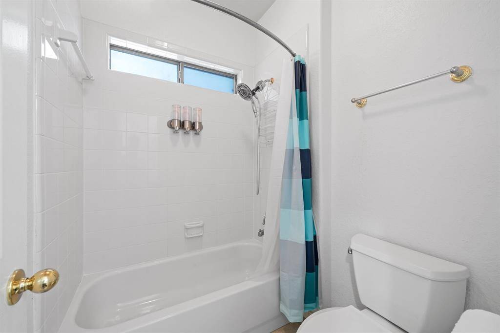 It is complete with wood tile flooring, shower/tub combo, tile wall and a window that provides plenty of light.