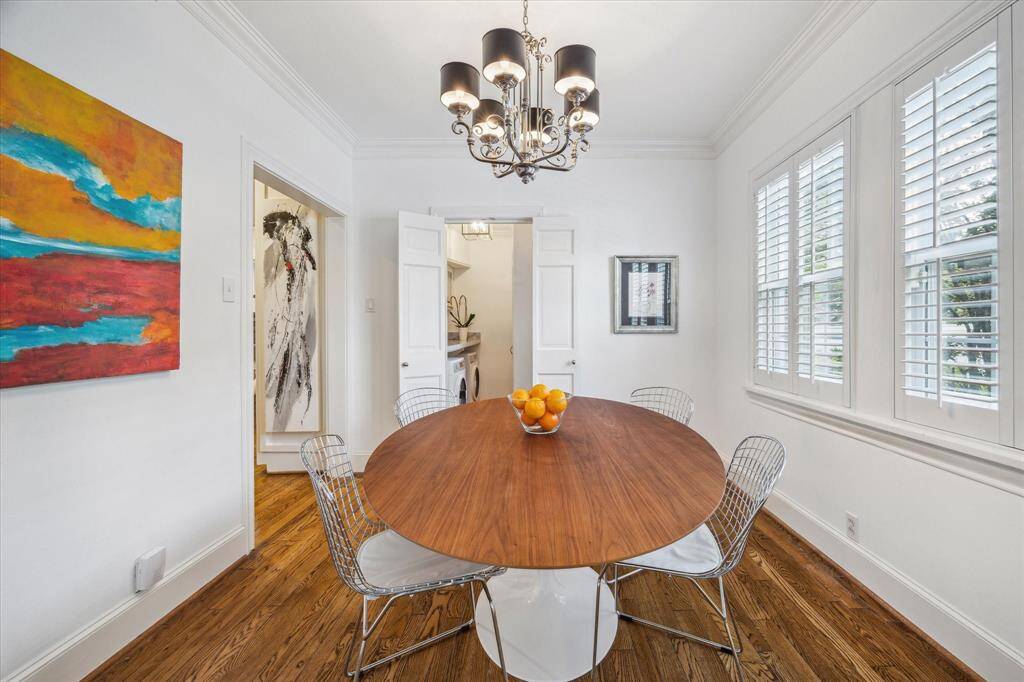 The breakfast room is afford north facing windows overlooking the pool.  The doorway to the left leads to the kitchen while the bi-fold doors in center frame open to the laundry room and cabana bath.