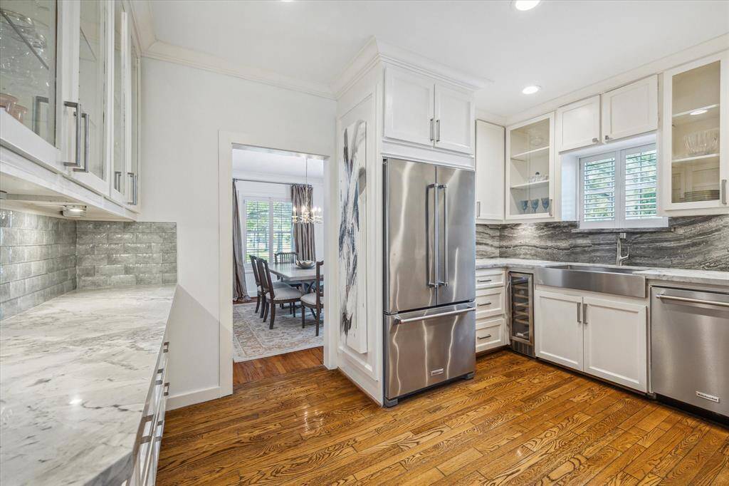 Here is another view of the kitchen with the dining room on the other side of the entry.  Notice the wine fridge to the right of the KitchenAid refrigerator.