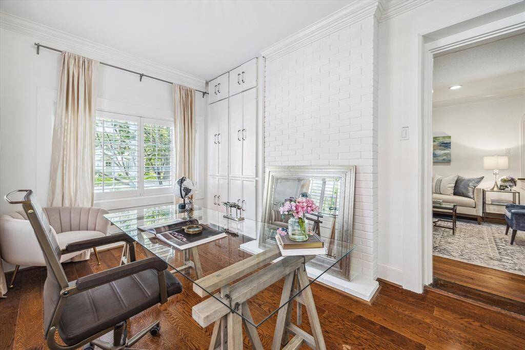 Here is an image of the home office that shows the second built-in next to the window.  The mirror in front of the desk conceals the double-sided fireplace.  The main living room is to the right.
