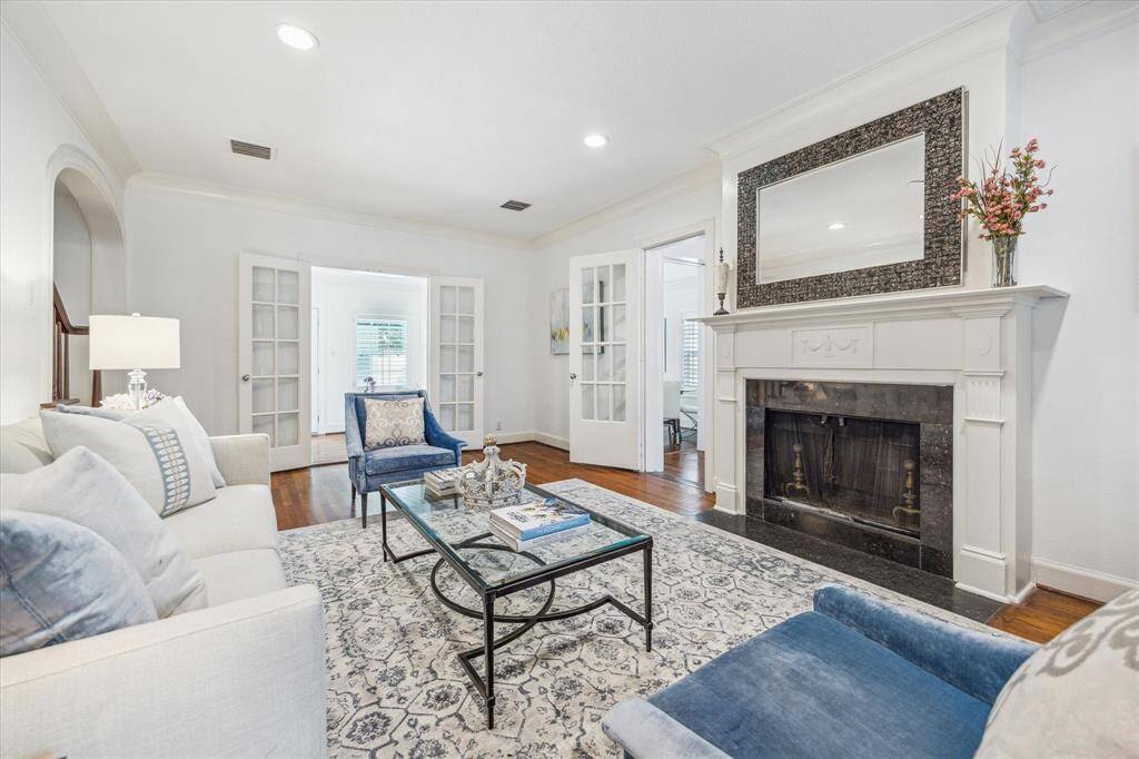 Here is a picture of the main living room with the doors leading to the flex room and home office in center frame.  To the left, just on the other side of the lamp is the vestibule that leads you to the stairs.