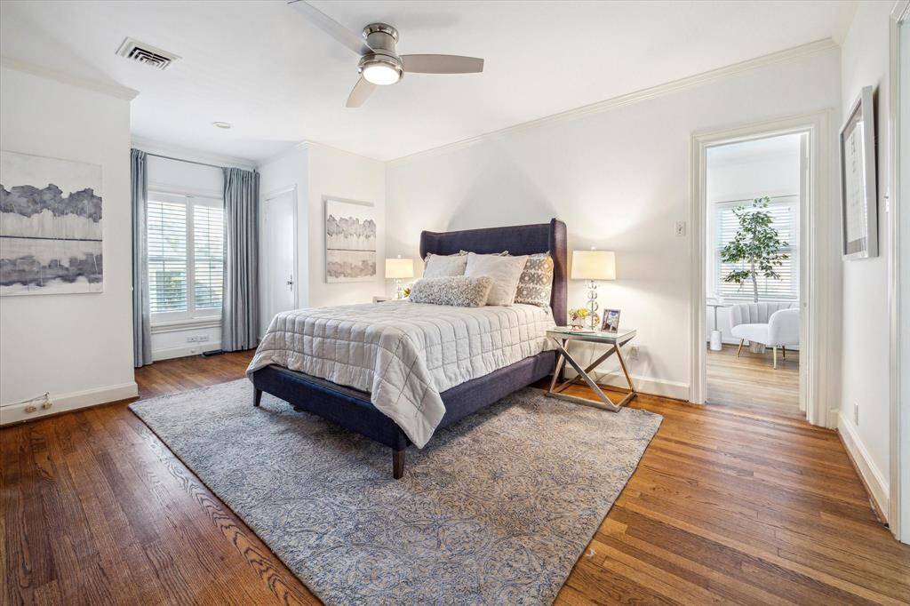 The master bedroom measures 19' in width and has north facing windows overlooking the swimming pool.  There are two oversized wardrobe closets, one on each side of the window.  The doorway to the right leads to the sunroom.