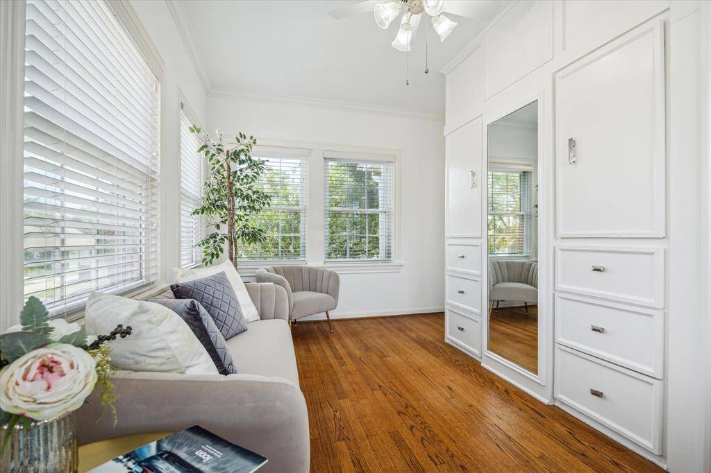 From this angle in the sunroom, you can see the wall of the wardrobe where you will find an abundance of drawers and doors that keep your clothing garments free from dust.  This room could also be utilized as a secondary home office or as a nursery.