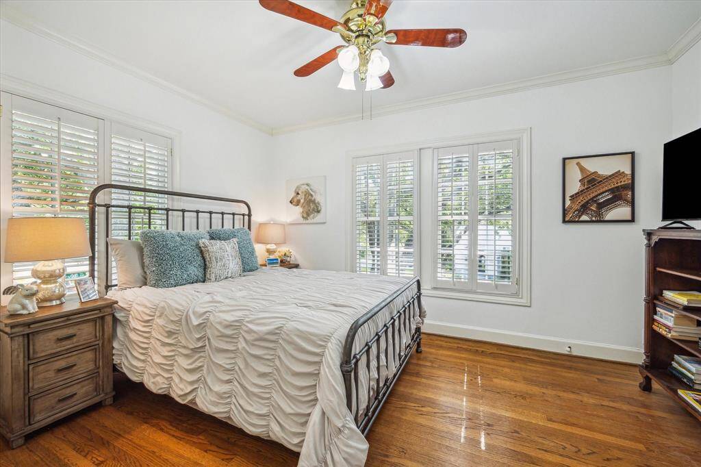 This secondary bedroom has south and west facing windows with plantation shutters.  Notice the handsome hardwood floors which can be found throughout the second floor.