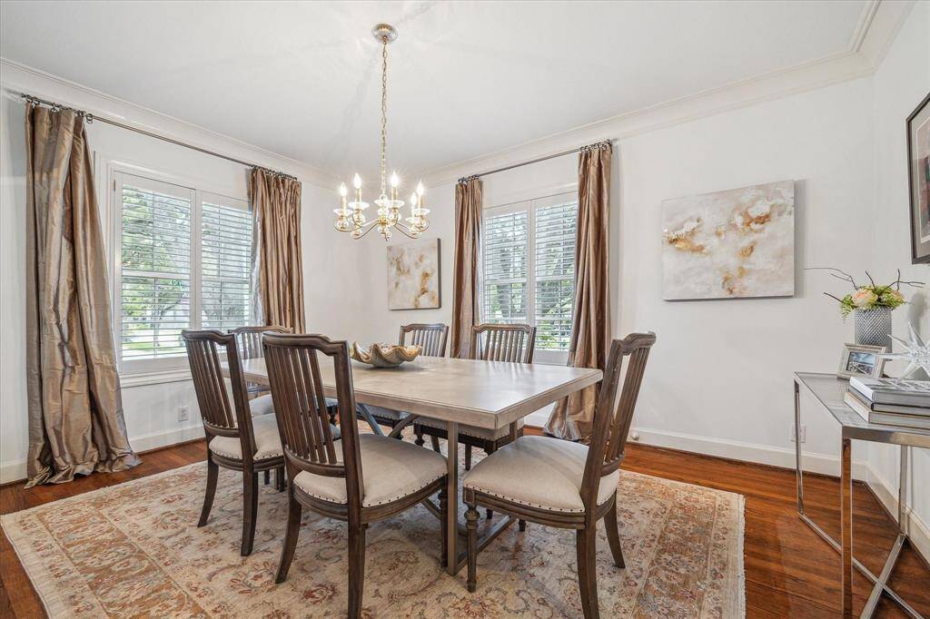 The dining room has crown molding , a seven-light chandelier and south and west facing windows.
