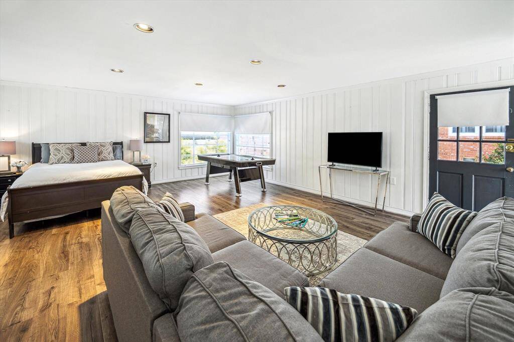 This guest suite has space for a living area, the queen-size bed to the left and a full size air hockey table.