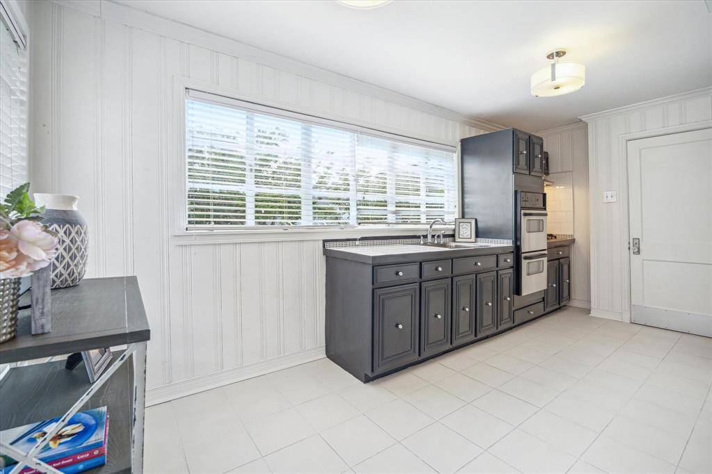 Here is another view of the kitchen.  A bistro table could be situated to the left of the custom built cabinets.  The doorway to the right opens to the full bath.