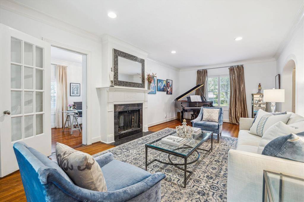 Here is another view of the 26' x 13' living room with the double-sided, wood burning fireplace.  The study/home office is just beyond the door to the left of the fireplace.