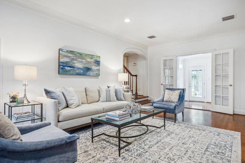 From this angle, you are able to see how the family room connects to the den which is found on the other side of the glass French doors.