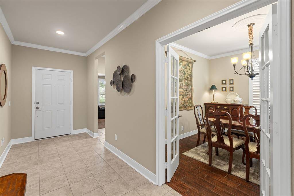 This home features upgraded 5¼" baseboards, elegant crown molding, and durable tile flooring throughout the main living areas—adding both style and sophistication.