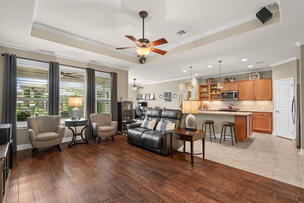 The gathering room flows effortlessly into the kitchen, creating a perfect space for easy living and seamless entertaining.