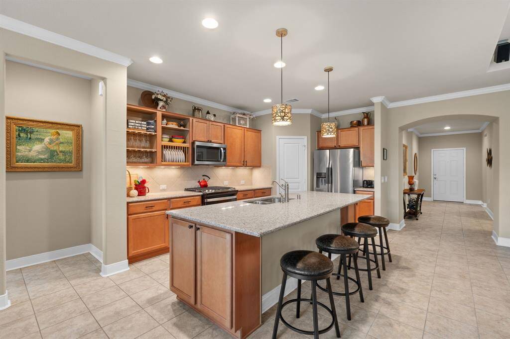 Ample storage with extra cabinets at both ends of the island, plus a spacious walk-in pantry to keep everything organized and within reach.