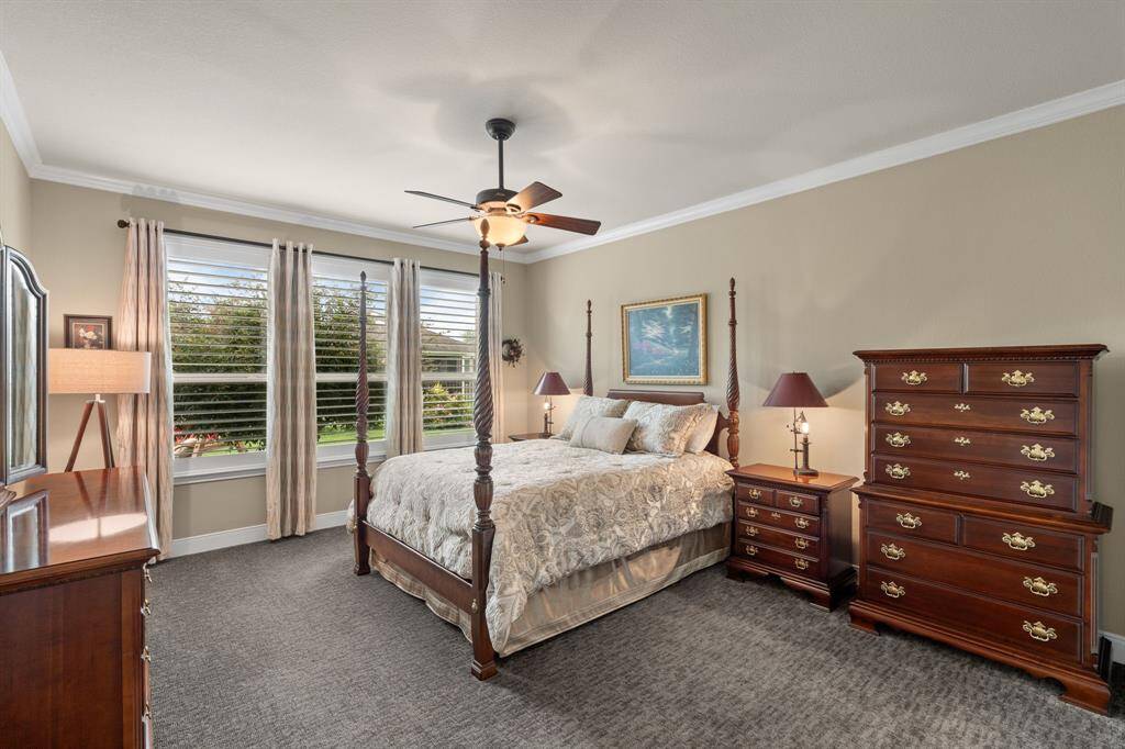 The owner’s suite offers plenty of room for a king bed, nightstands, and dresser, beautifully accented by crown molding and elegant shutters.