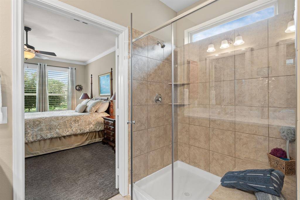 Shower featuring a spacious bench—a great place to relax and unwind after a day of pickleball at Del Webb.