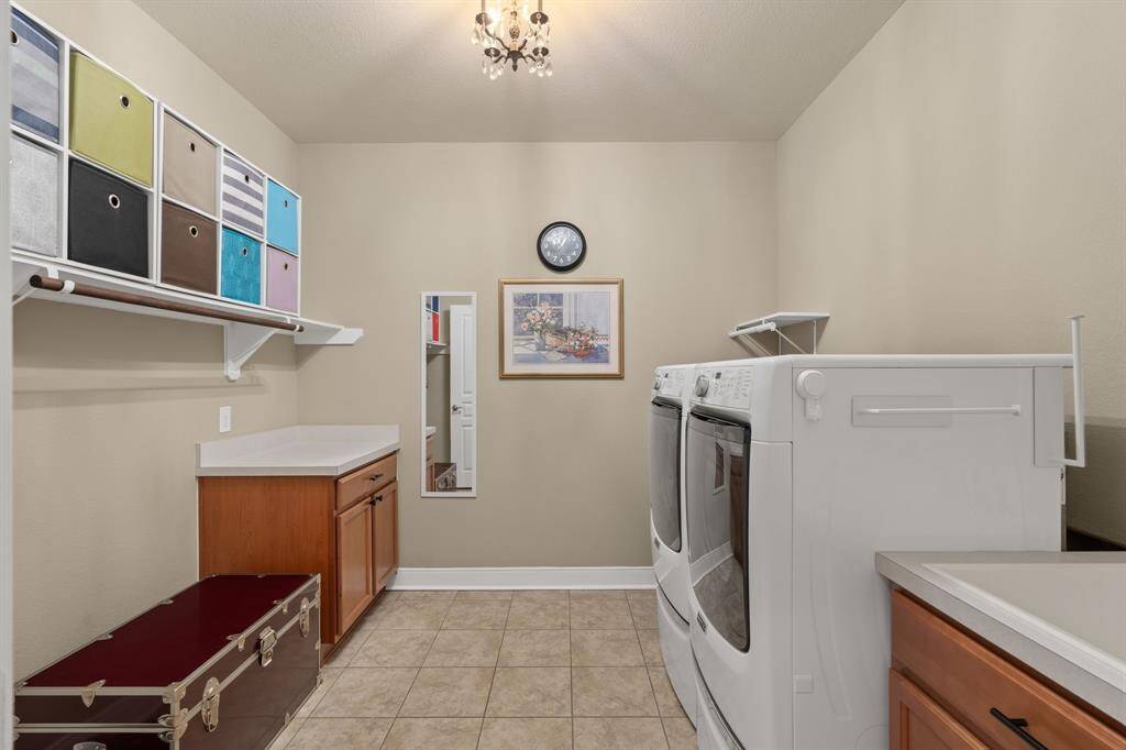 Handy sink, built-in shelves, and cabinets with countertop space make organization easy. A special chandelier adds a stylish accent to the room.