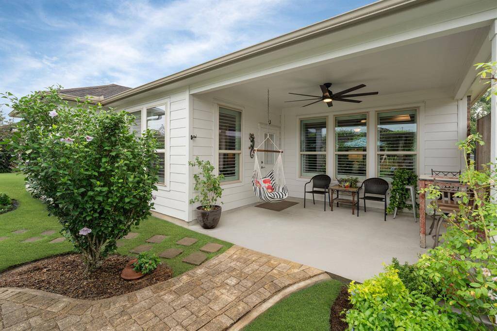 East-facing patio featuring a large ceiling fan—perfect for enjoying cool breezes on warm mornings.