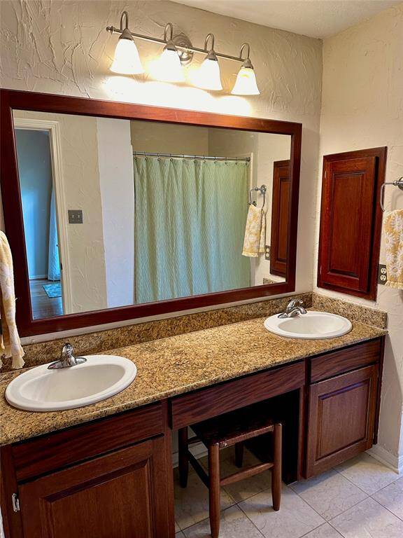 Primary bedroom with double sinks and vanity area.