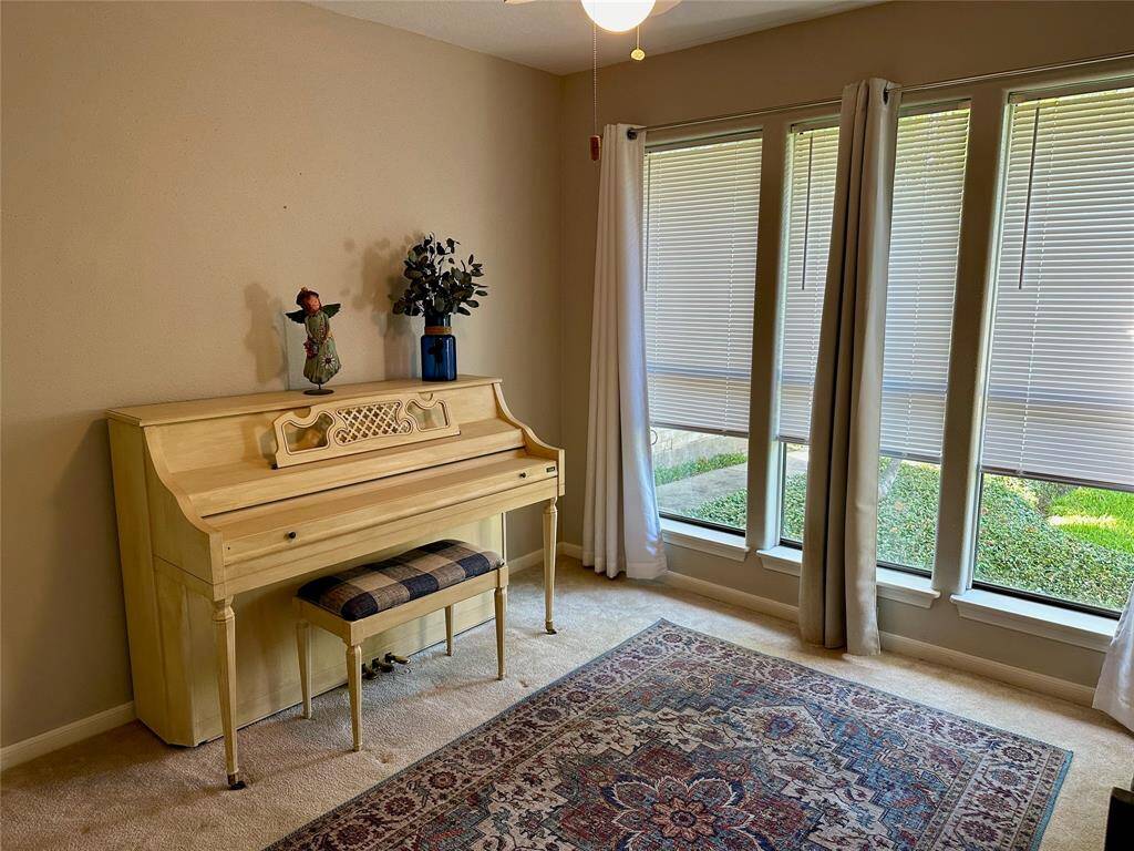 This secondary bedroom is currently the piano room with an abundance of natural light.