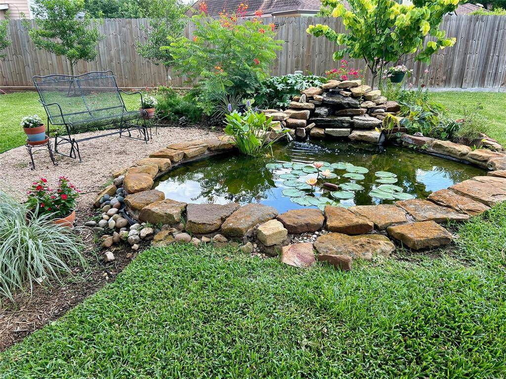 A delightful koi pond with sitting area to watch the fish.