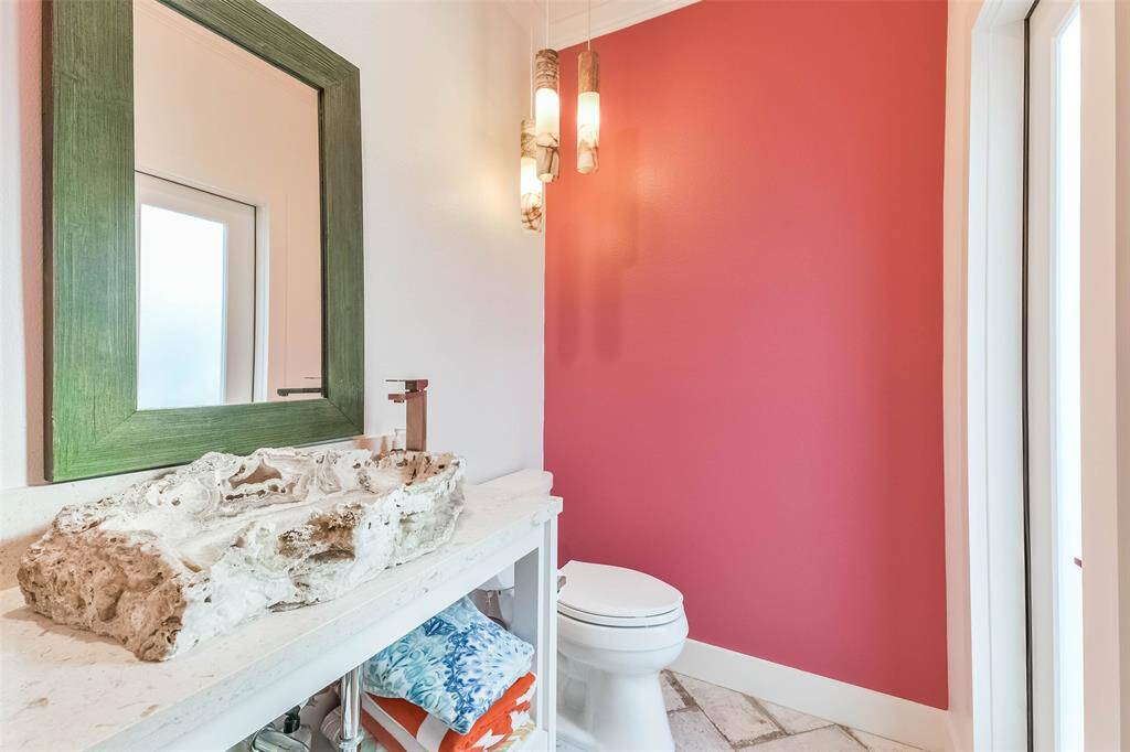 Second half  bath near kitchen and with door to the pool area.