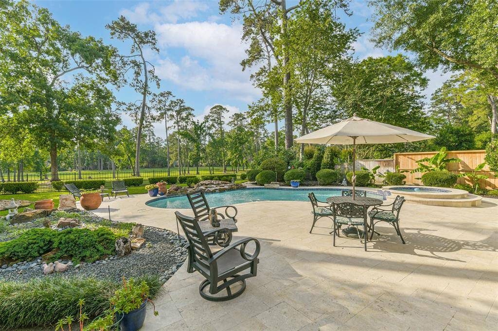 Plenty of space for patio furniture by the pool.